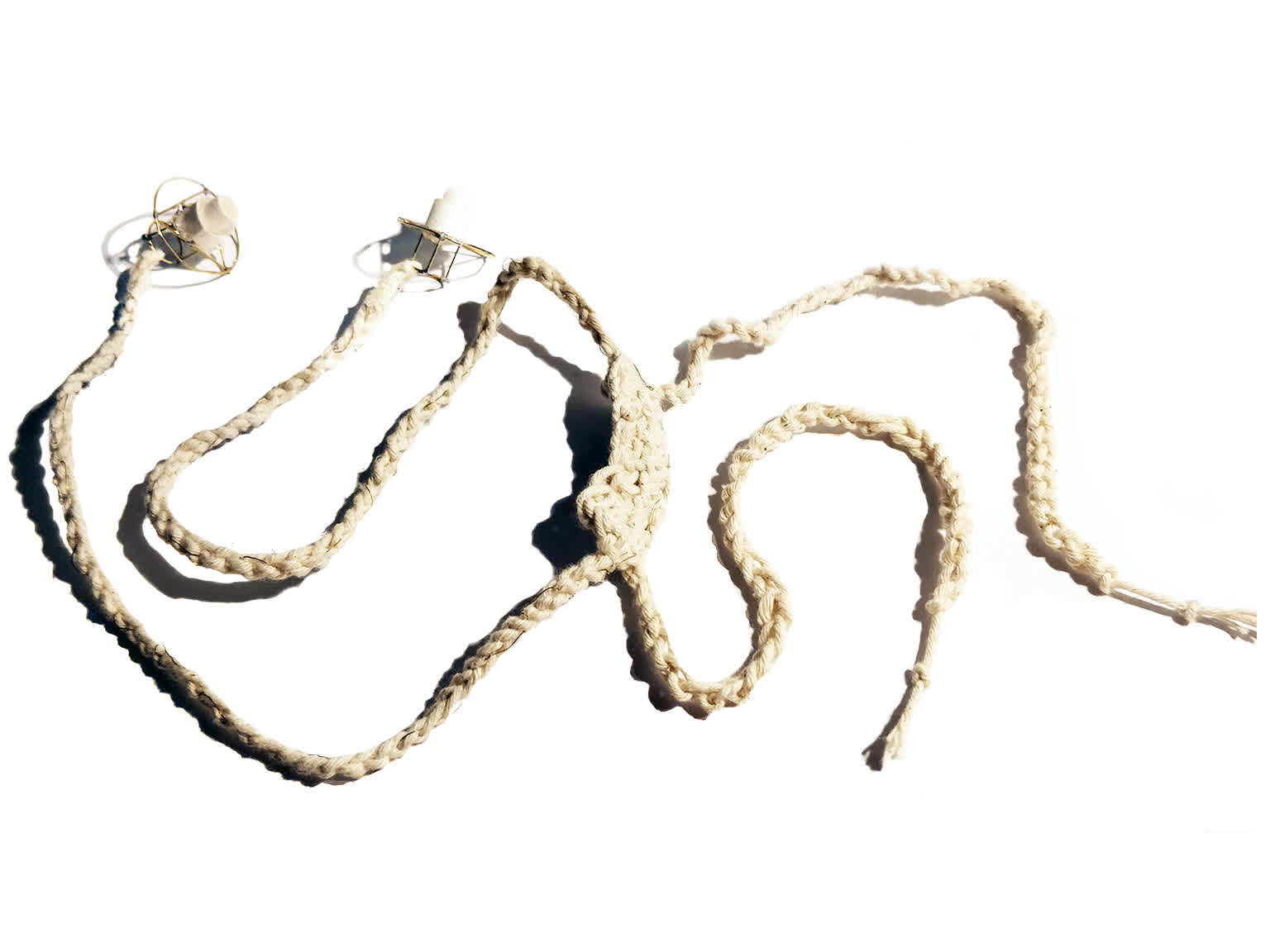 wire earbuds with a crochet string cable. The soft cable is meant to tie up hair