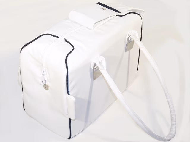 The bag from above, with the zipper-cover part opened, showing the zipper and clasp